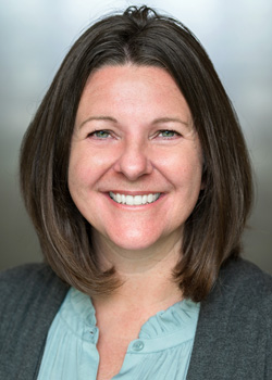 Headshot of Robin Lemaire. She has brown hair and a blue shirt