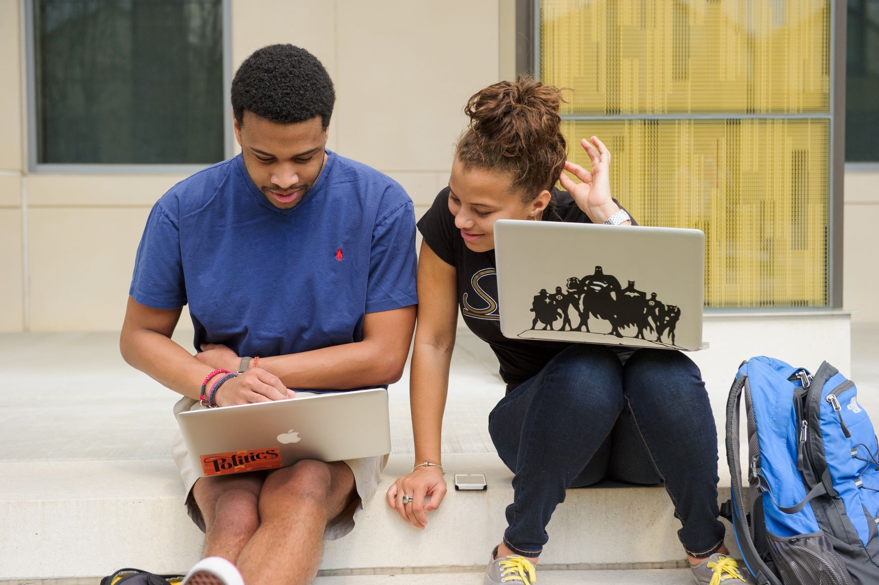 Studnets with laptops outside. 