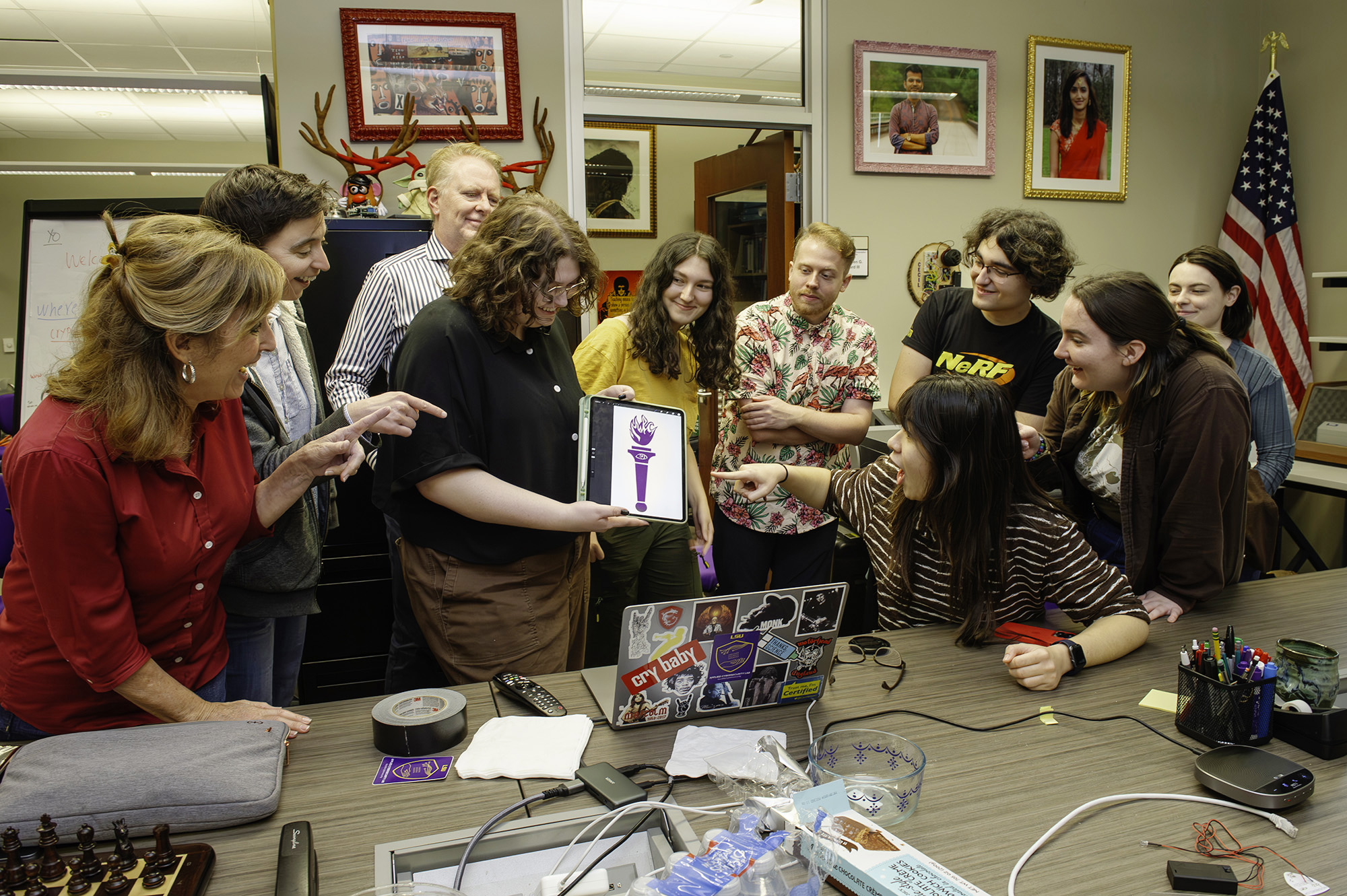 LSU faculty and students in the LSU Applied Cybersecurity Lab viewing symbols on a computer tablet.