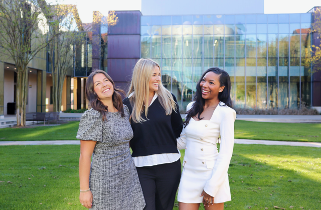 three girls smiling at camera
