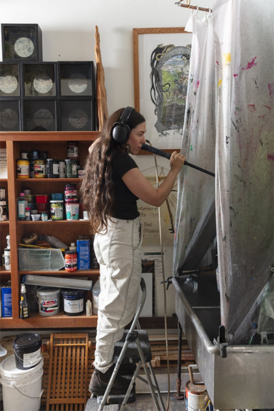 Pippin Frisbie-Calder working in her art studio